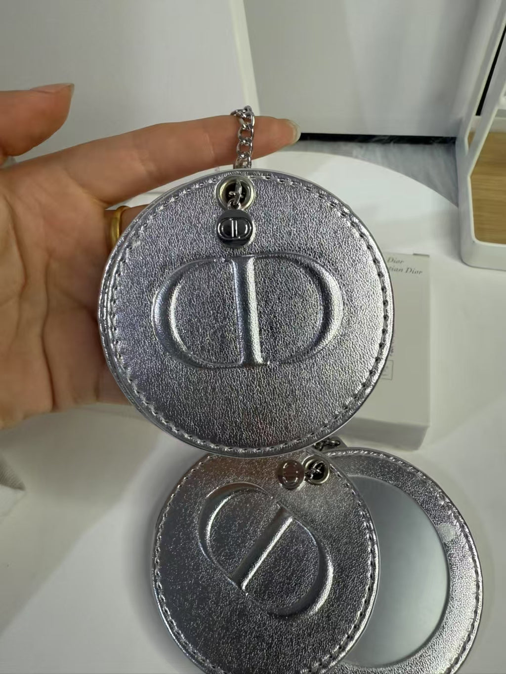 D-IOR silver lambskin compact mirror – complimentary VIP gift.