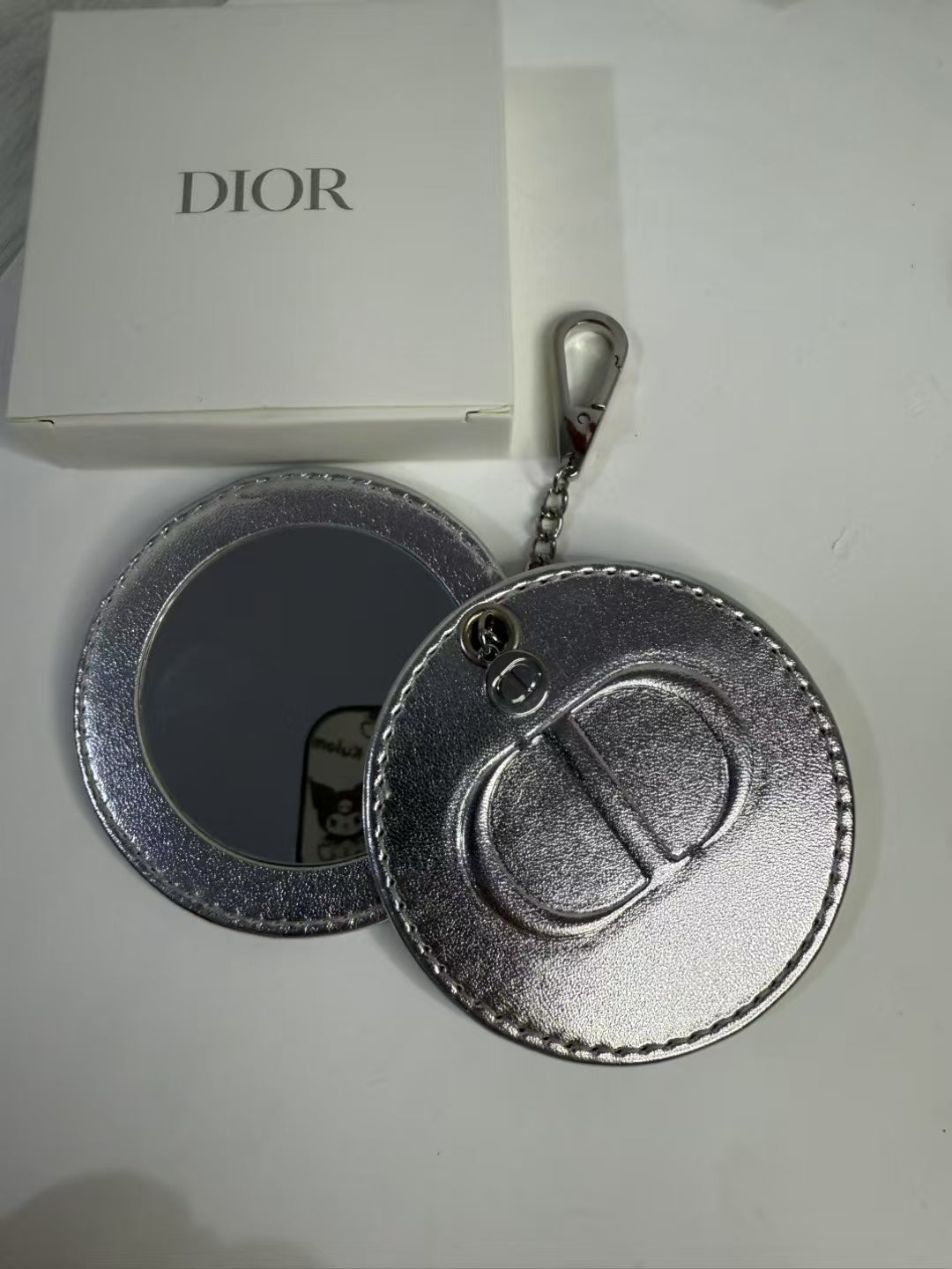 D-IOR silver lambskin compact mirror – complimentary VIP gift.